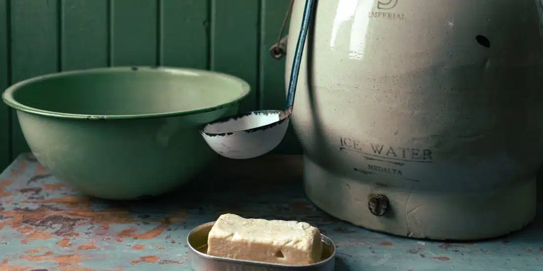 stainless steel cooking pot beside white ceramic bowl