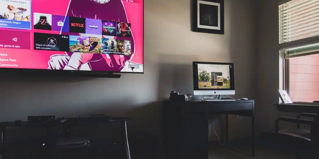 black flat screen tv turned on near black wooden table